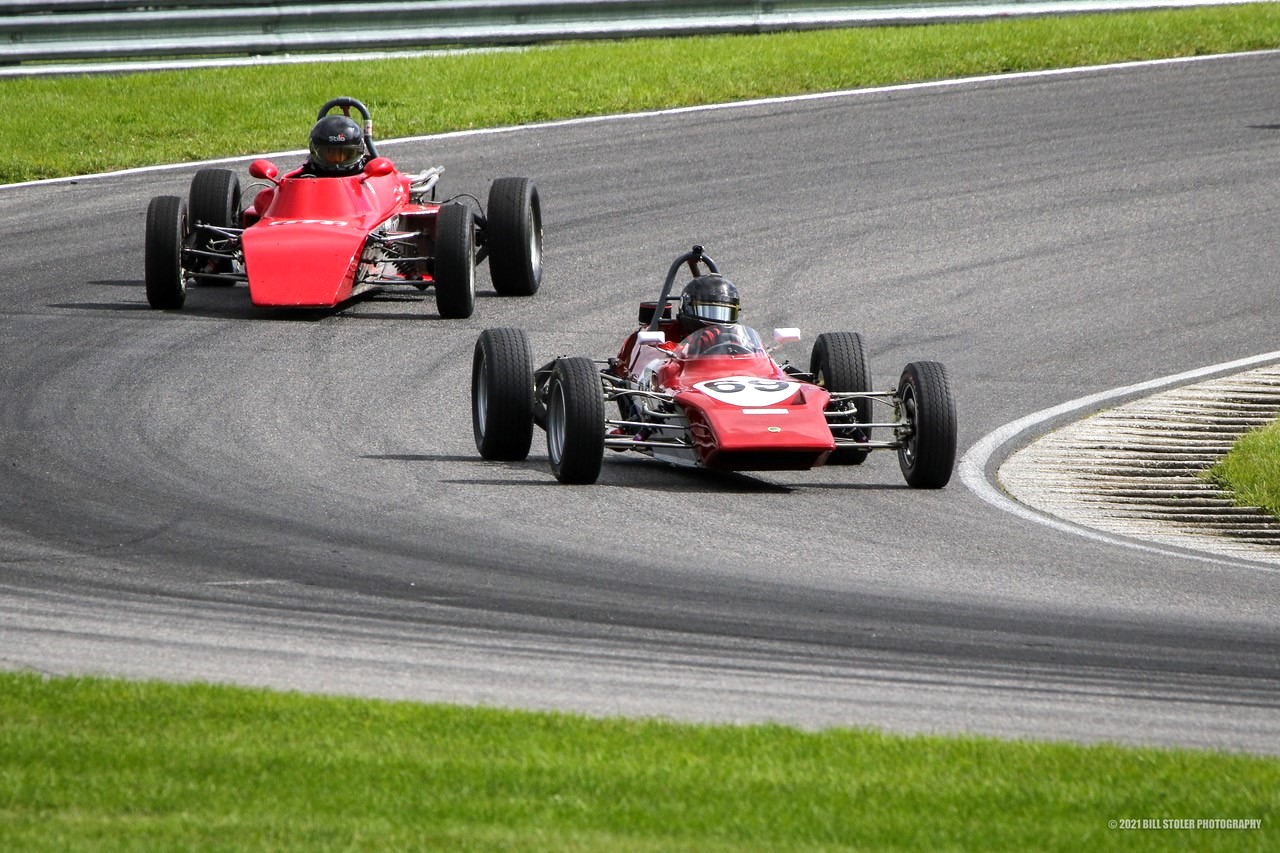 Two race cars on a trackDescription automatically generated